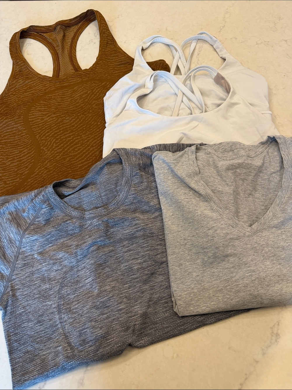 Lululemon bundle. 3 shirts 2 sports bras. Size 12